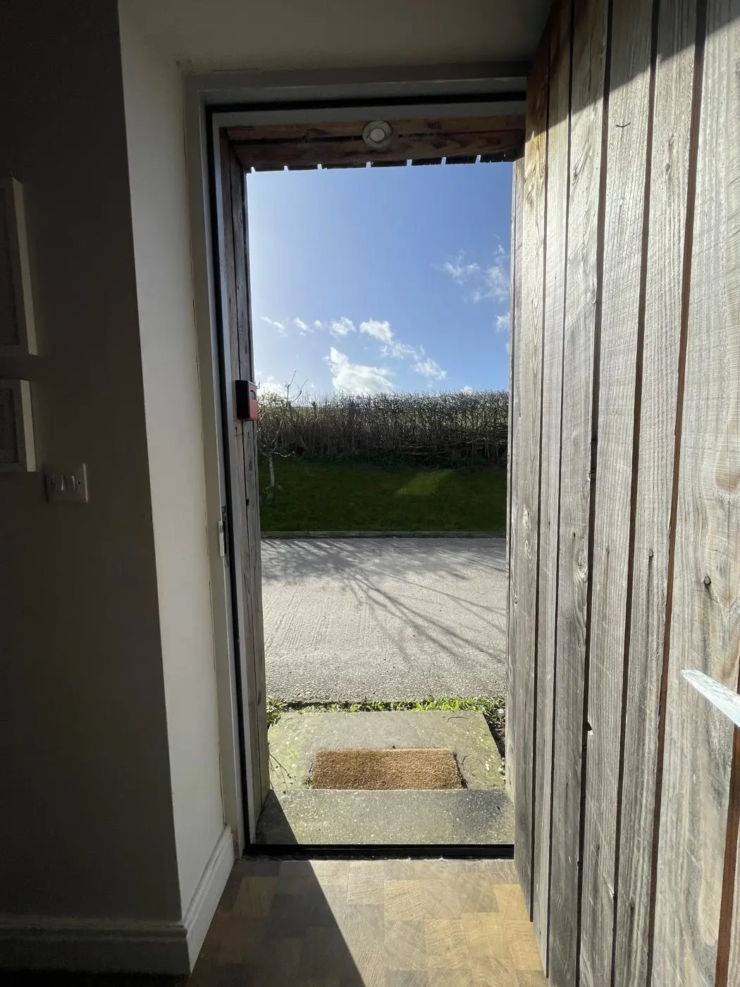 The studio door open onto the lane, hedgerow and sky