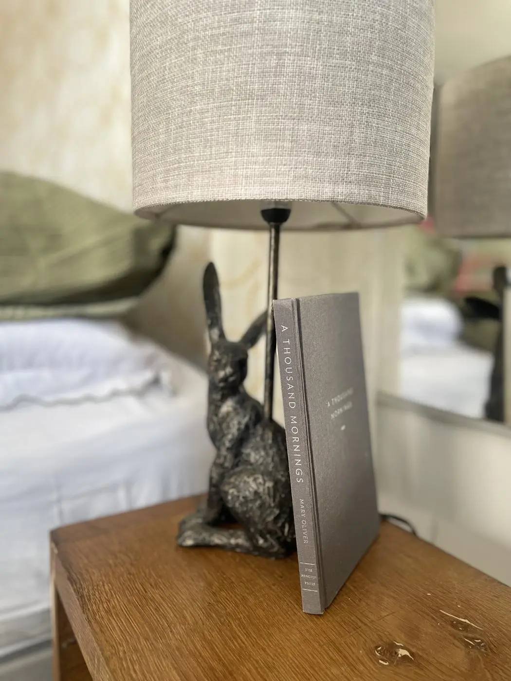 A hare lamp and a book of poems by the bed