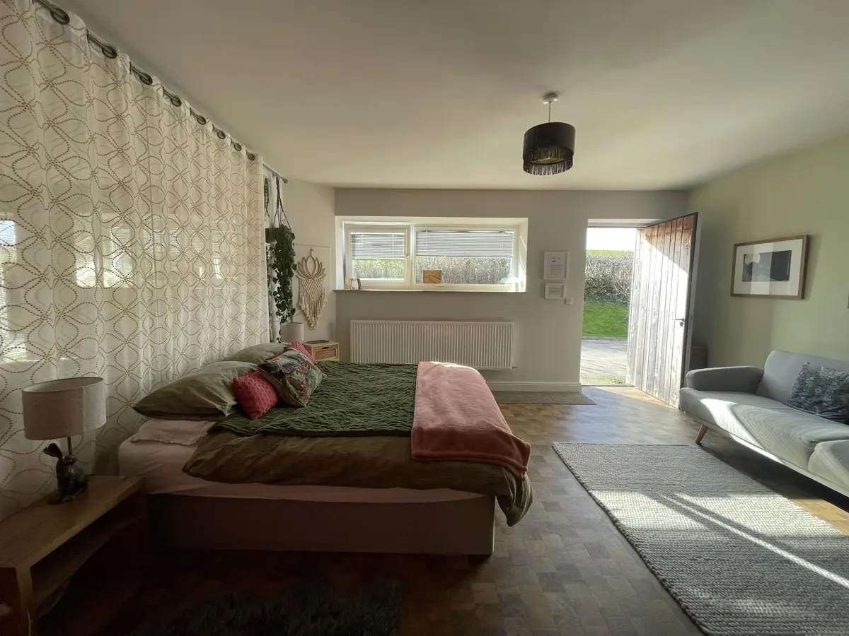 The studio: double bed, sofa bed and the barn door open to the hedgerow